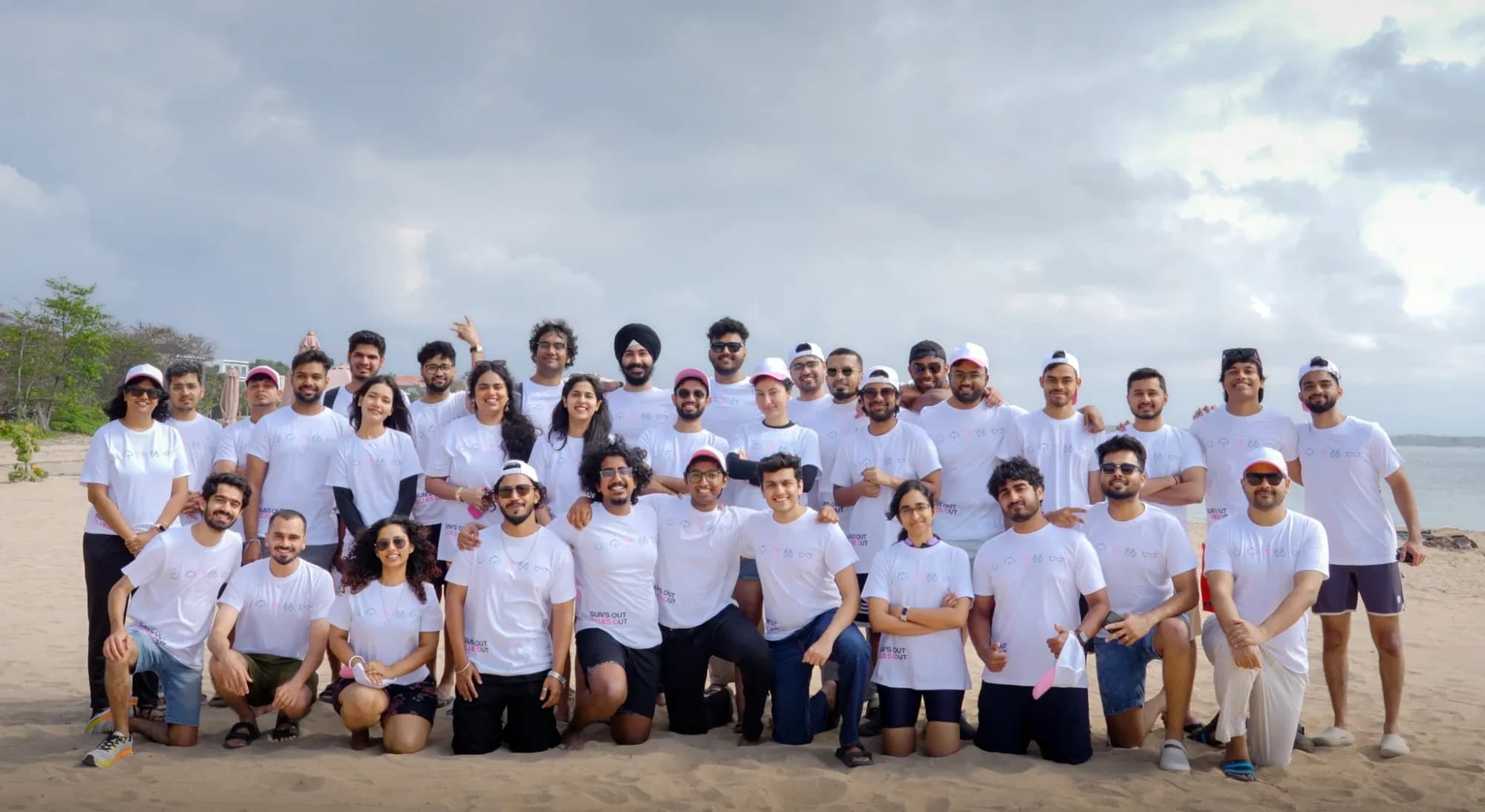 The Clueso team together on a beach, wearing matching white Clueso t-shirts